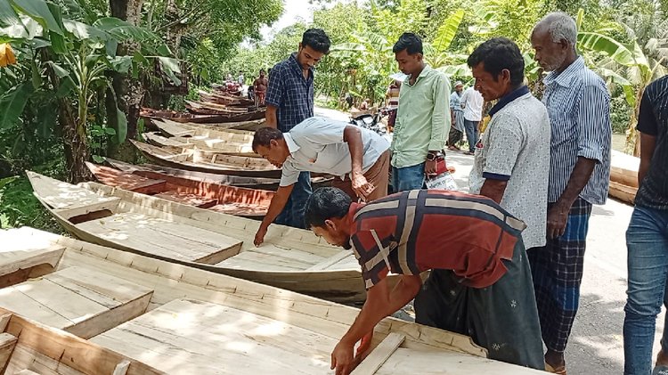 খালের পাশে সড়কে নৌকার দরদাম করছেন ক্রেতারা। ছবি: আজকের পত্রিকা