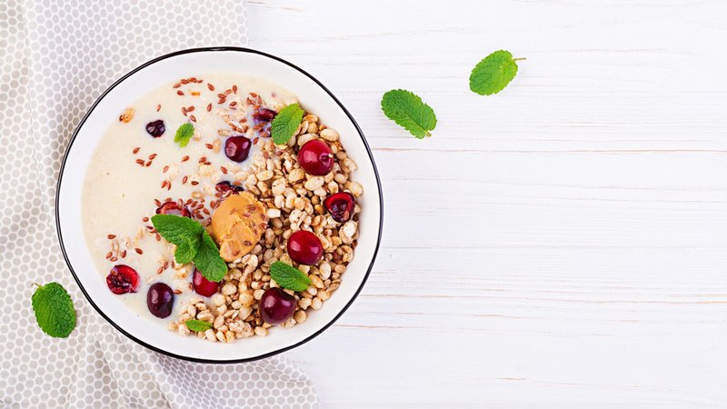 bowl-homemade-granola-with-banana-mashed-peanut-butter-fresh-berries_2829-10661