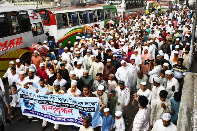 গ্যাস–সংকট নিরসনের দাবিতে আজ জুমার নামাজের পর যাত্রাবাড়ীর ধলপুর কমিউনিটি সেন্টারের সামনে বিক্ষুব্ধ গ্রাহকেরা মানববন্ধন কর্মসূচি পালন করেন। ছবি: আজকের পত্রিকা