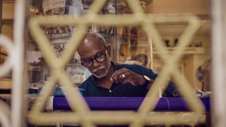 সারা আন্টির দোকানে কিপ্পা সেলাই করছেন ইব্রাহিম থাহা। ছবি: বিবিসির সৌজন্যে