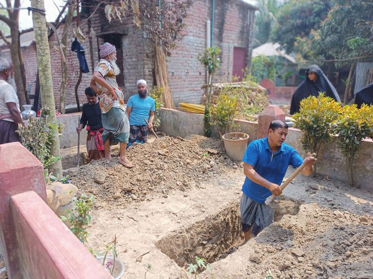 মাদারীপুর সদরের খোয়াজপুরে লাশ দাফনের জন্য কবর খনন করা হচ্ছে। ছবি: আজকের পত্রিকা