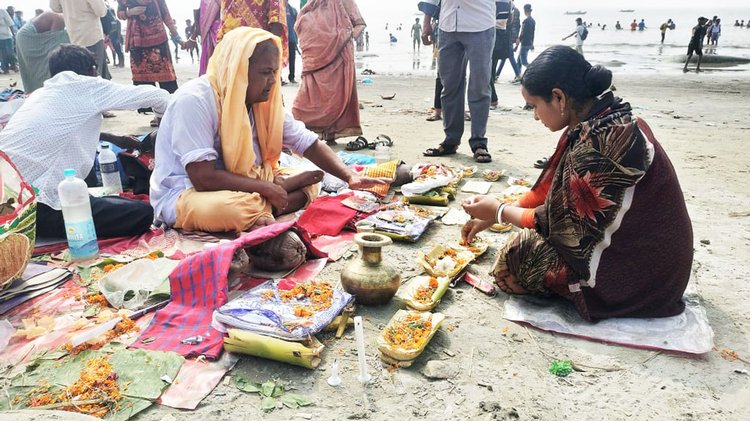 কুয়াকাটা সৈকতে পূজা করছেন পুণ্যার্থীরা। ছবি: আজকের পত্রিকা