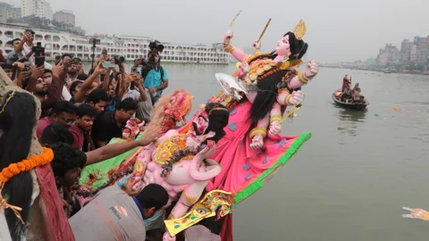 আবিরের রঙে আনন্দ-বিষাদে দেবী প্রতিমা বিসর্জন