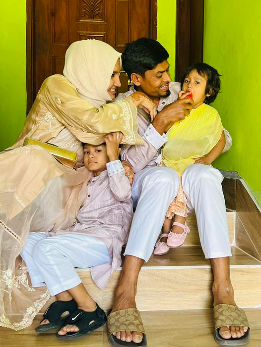 বাসার দরজার সামনে বসে মেয়েকে খাবার খাওয়ানোর চেষ্টা করছেন বাঁ হাতি স্পিনার তাইজুল ইসলাম। অন্যদিকে মায়ের কোল থেকে উঁকি মারছেন বাংলাদেশি ক্রিকেটারের পুত্র। ছবি: ফেসবুক