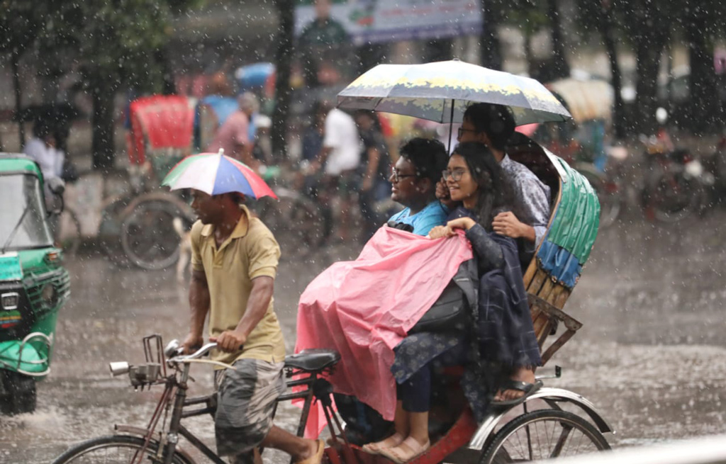 ঝুম বৃষ্টির মধ্যই রিকশায় করে ক্লাসে যাচ্ছিলেন বন্ধুরা। ছবি: আজকের পত্রিকা