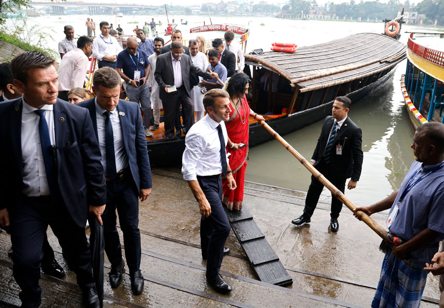ভ্রমণ শেষে কাঠের সিঁড়ি দিয়ে ঘাটে নামেন ইমানুয়েল মাখোঁ। তাঁর সঙ্গে সফরসঙ্গীসহ বাংলাদেশ সরকারের কর্মকর্তা ও এনজিও কর্মী ছিলেন। 