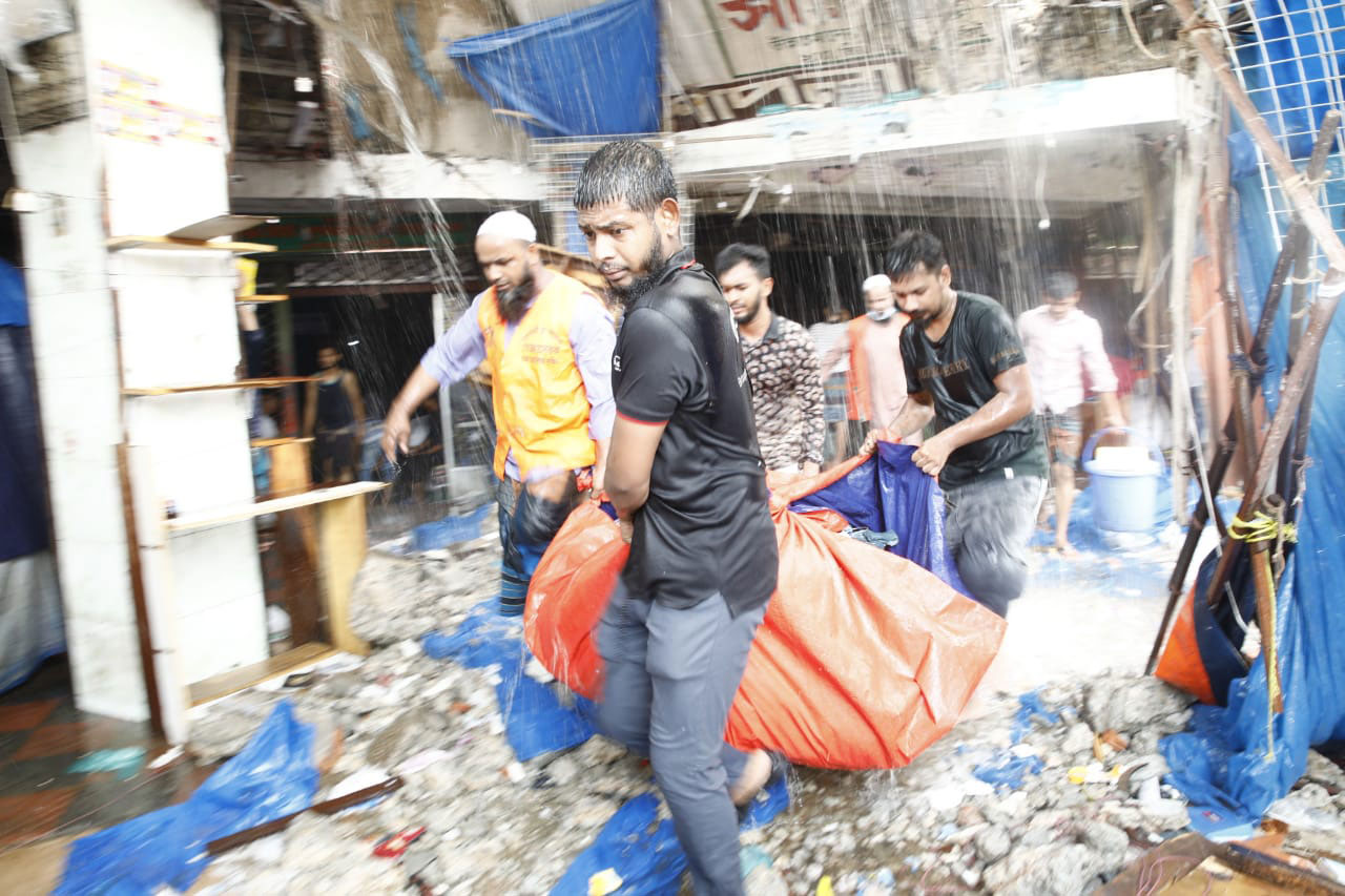 ধ্বংসস্তূপ থেকে ঠিক থাকা মালামাল বের করে নিয়ে যাচ্ছেন ব্যবসায়ীরা