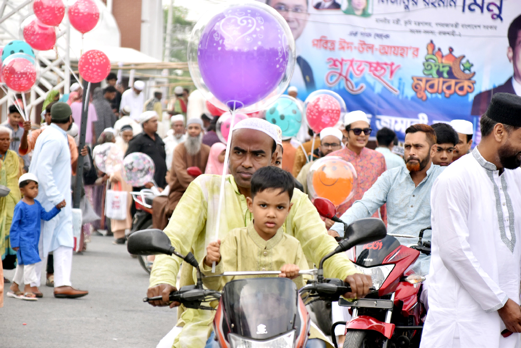 রাজশাহীতে পবিত্র ঈদুল আজহার নামাজ আদায় করে কেন্দ্রীয় ঈদের মাঠ থেকে বের হয়ে বেলুন নিয়ে বাড়ি ফিরছে শিশুরা। ছবিটি আজ সকালে পাঠানপাড়া এলাকা থেকে তোলা। ছবি: মিলন শেখ