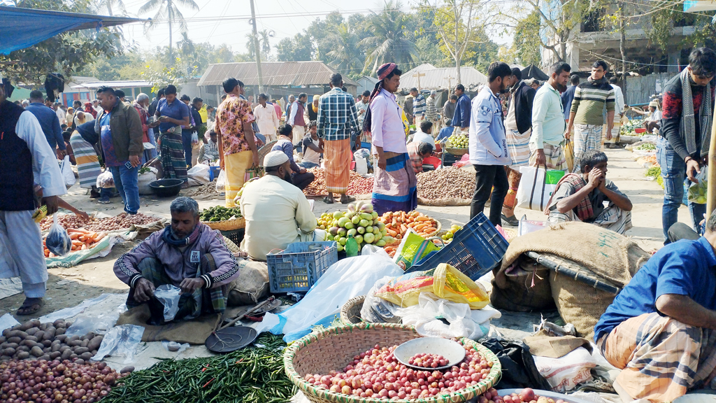 হাটে আলু, টমেটো, বেগুন, মিষ্টিকুমড়াসহ বিভিন্ন শীতকালীন শাকসবজি কেনাবেচায় ব্যস্ত ক্রেতা-বিক্রেতা। পাবনার চাটমোহর উপজেলার অমৃতকুন্ডা হাট এটি। প্রতি সপ্তাহের রোববার এই হাট বসে। উপজেলার বিভিন্ন এলাকা থেকে লোকজন এখানে কেনাকাটা করতে আসেন। আজ রোববার দুপুরে তোলা। ছবি: শুভাশীষ ভট্টাচার্য্য তুষার